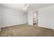 Carpeted main bedroom leads to en-suite bathroom with dual vanities at 9837 E Tiburon Ave, Mesa, AZ 85212