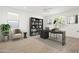 Bright home office featuring built-in bookcase, stylish desk and chair, and natural light at 9837 E Tiburon Ave, Mesa, AZ 85212