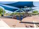 A vibrant playground with colorful equipment and a shaded canopy, perfect for recreation at 9837 E Tiburon Ave, Mesa, AZ 85212