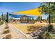 Well-maintained community playground with modern play structures and soft, engineered wood fiber surfacing at 9837 E Tiburon Ave, Mesa, AZ 85212