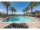 A sleek and stylish pool framed by palm trees and lounge chairs, ideal for relaxation and leisure at 9837 E Tiburon Ave, Mesa, AZ 85212