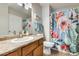 Bathroom with a single sink, wooden cabinet, desert cactus shower curtain, and tile flooring at 9990 N Scottsdale Rd # 2042, Paradise Valley, AZ 85253