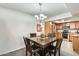 Cozy dining area adjacent to the kitchen with wood table and dark wood chairs under a chandelier at 9990 N Scottsdale Rd # 2042, Paradise Valley, AZ 85253