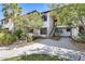 Condo exterior with red tile roof, mature landscaping, covered stairs, and light-colored walls at 9990 N Scottsdale Rd # 2042, Paradise Valley, AZ 85253