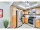 Well-organized kitchen with stainless steel appliances, light wood cabinets, and modern lighting at 9990 N Scottsdale Rd # 2042, Paradise Valley, AZ 85253