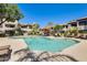 Community pool with lounge chairs and seating areas around the pool deck, surrounded by apartment buildings at 9990 N Scottsdale Rd # 2042, Paradise Valley, AZ 85253