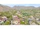 Breathtaking aerial view showcases the luxurious home nestled amidst scenic mountains, golf course, and lush landscapes at 10182 E Gilded Perch Dr, Scottsdale, AZ 85255