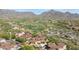 Stunning aerial view of a desert community, with golf course, mountain views, and elegant homes with tile roofs at 10182 E Gilded Perch Dr, Scottsdale, AZ 85255