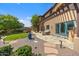Inviting backyard features a manicured lawn, stone patio, seating, and lush landscaping in a luxurious outdoor space at 10182 E Gilded Perch Dr, Scottsdale, AZ 85255