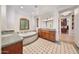 Luxurious bathroom featuring dual vanities, a soaking tub, and a walk-in closet at 10182 E Gilded Perch Dr, Scottsdale, AZ 85255