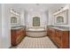 Elegant bathroom features dual vanities, a soaking tub, and natural light from a shuttered window at 10182 E Gilded Perch Dr, Scottsdale, AZ 85255