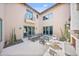 Open-air courtyard with a patio seating area, desert landscaping, and access to the home at 10182 E Gilded Perch Dr, Scottsdale, AZ 85255