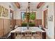 Bright dining room featuring wood accents, custom lighting, and outdoor views at 10182 E Gilded Perch Dr, Scottsdale, AZ 85255