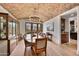 Dining room with brick ceiling, hardwood floors, and large windows overlooking the backyard at 10182 E Gilded Perch Dr, Scottsdale, AZ 85255