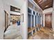 Bright foyer with stone floors, mudroom-style storage, and views of the living room and library at 10182 E Gilded Perch Dr, Scottsdale, AZ 85255
