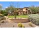 Southwestern home showcasing desert landscaping with cacti and a curving retaining wall at 10182 E Gilded Perch Dr, Scottsdale, AZ 85255