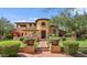 Mediterranean-style home featuring a terracotta roof, landscaped yard, and charming architectural details at 10182 E Gilded Perch Dr, Scottsdale, AZ 85255