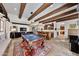 Entertain in this game room featuring a pool table, bar area, and seamless transition to living spaces at 10182 E Gilded Perch Dr, Scottsdale, AZ 85255