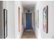 Bright hallway decorated with colorful art and a blue storage cabinet, enhancing the home's modern appeal at 10182 E Gilded Perch Dr, Scottsdale, AZ 85255