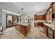Spacious kitchen features an island, stainless steel appliances, custom cabinets, and tile flooring at 10182 E Gilded Perch Dr, Scottsdale, AZ 85255