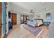 Spacious main bedroom with hardwood floors, ceiling fan, and private balcony access at 10182 E Gilded Perch Dr, Scottsdale, AZ 85255