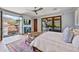 Bright main bedroom with a balcony, a ceiling fan, and hardwood flooring at 10182 E Gilded Perch Dr, Scottsdale, AZ 85255