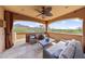 Covered outdoor living area features comfortable seating and scenic mountain views at 10182 E Gilded Perch Dr, Scottsdale, AZ 85255