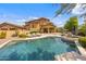 Stunning backyard pool with lush landscaping provides a private retreat for relaxation and entertainment at 10182 E Gilded Perch Dr, Scottsdale, AZ 85255