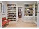 Luxurious walk-in closet featuring custom shelving for shoes and handbags, plus wooden floors for an elegant touch at 10182 E Gilded Perch Dr, Scottsdale, AZ 85255