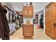 Organized walk-in closet featuring extensive hanging space, custom drawers, and shelving for a streamlined wardrobe at 10182 E Gilded Perch Dr, Scottsdale, AZ 85255