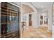 Hallway view of dining room with brick ceiling, hardwood floors, and visible wine storage at 10182 E Gilded Perch Dr, Scottsdale, AZ 85255