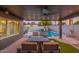 Stunning outdoor space with a covered patio, dining area, lush turf, and a pool with a rock waterfall feature at 10240 N 34Th Pl, Phoenix, AZ 85028