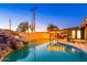 Inviting backyard pool with rock waterfall feature, pergola, and manicured landscaping creates a serene outdoor oasis at 10240 N 34Th Pl, Phoenix, AZ 85028