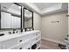 Bathroom featuring double vanity with black fixtures and black framed mirrors at 10240 N 34Th Pl, Phoenix, AZ 85028