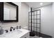 Modern bathroom featuring a black framed shower, black hardware, and modern vanity and mirror at 10240 N 34Th Pl, Phoenix, AZ 85028