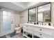 Modern bathroom with double sinks, white cabinets, and black fixtures, offering ample space at 10240 N 34Th Pl, Phoenix, AZ 85028