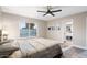 Well-lit bedroom with a large window, stylish artwork, and an en-suite bathroom at 10240 N 34Th Pl, Phoenix, AZ 85028