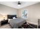 Cozy bedroom with modern lighting, a ceiling fan, neutral colors, a black-and-white quilt, and plantation shutters at 10240 N 34Th Pl, Phoenix, AZ 85028