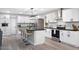 Contemporary kitchen equipped with stainless steel appliances, white cabinets, and an island with barstool seating at 10240 N 34Th Pl, Phoenix, AZ 85028