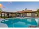 Inviting backyard pool and patio area featuring lounge seating and a covered pergola with cafe lights at 10240 N 34Th Pl, Phoenix, AZ 85028