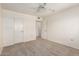 A clean bedroom with neutral carpet, ceiling fan, and view into a walk-in closet at 10401 N 108Th Ave, Sun City, AZ 85351