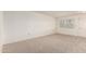 Spacious carpeted bedroom with neutral walls, a window, and white trim at 10401 N 108Th Ave, Sun City, AZ 85351