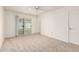 Large bedroom with carpet and sliding glass door access to outdoor patio area at 10401 N 108Th Ave, Sun City, AZ 85351