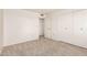 A clean bedroom with neutral carpet and ample closet space with a view into a walk-in closet at 10401 N 108Th Ave, Sun City, AZ 85351