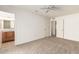 Generously sized bedroom with carpet flooring, ceiling fan and direct bathroom access at 10401 N 108Th Ave, Sun City, AZ 85351