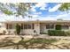 Charming single-story home with desert landscaping, mature trees, and window shutters at 10401 N 108Th Ave, Sun City, AZ 85351