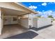 Driveway leading to a covered carport with an enclosed patio and white brick perimeter wall at 10401 N 108Th Ave, Sun City, AZ 85351