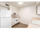 Efficient kitchen layout featuring white appliances and cabinets, ideal for cooking at 10401 N 108Th Ave, Sun City, AZ 85351