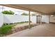 Covered patio area leading to a white brick perimeter wall with an external storage unit at 10401 N 108Th Ave, Sun City, AZ 85351