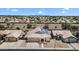 Aerial view of a home in a community with solar panels, a two car garage, and desert landscaping at 10809 W Harmony Ln, Peoria, AZ 85373